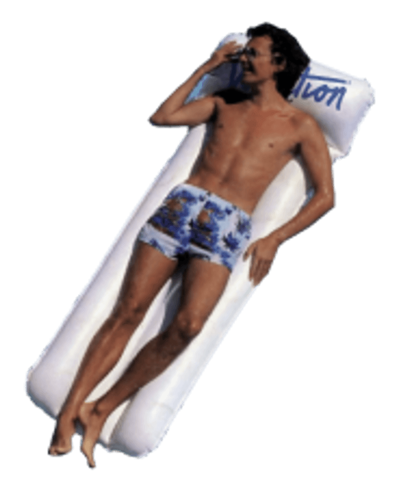 a shirtless man is laying on a raft that says vacation